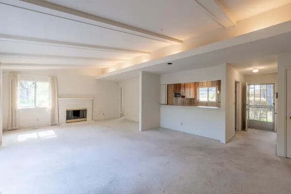 a view of empty room with a fireplace
