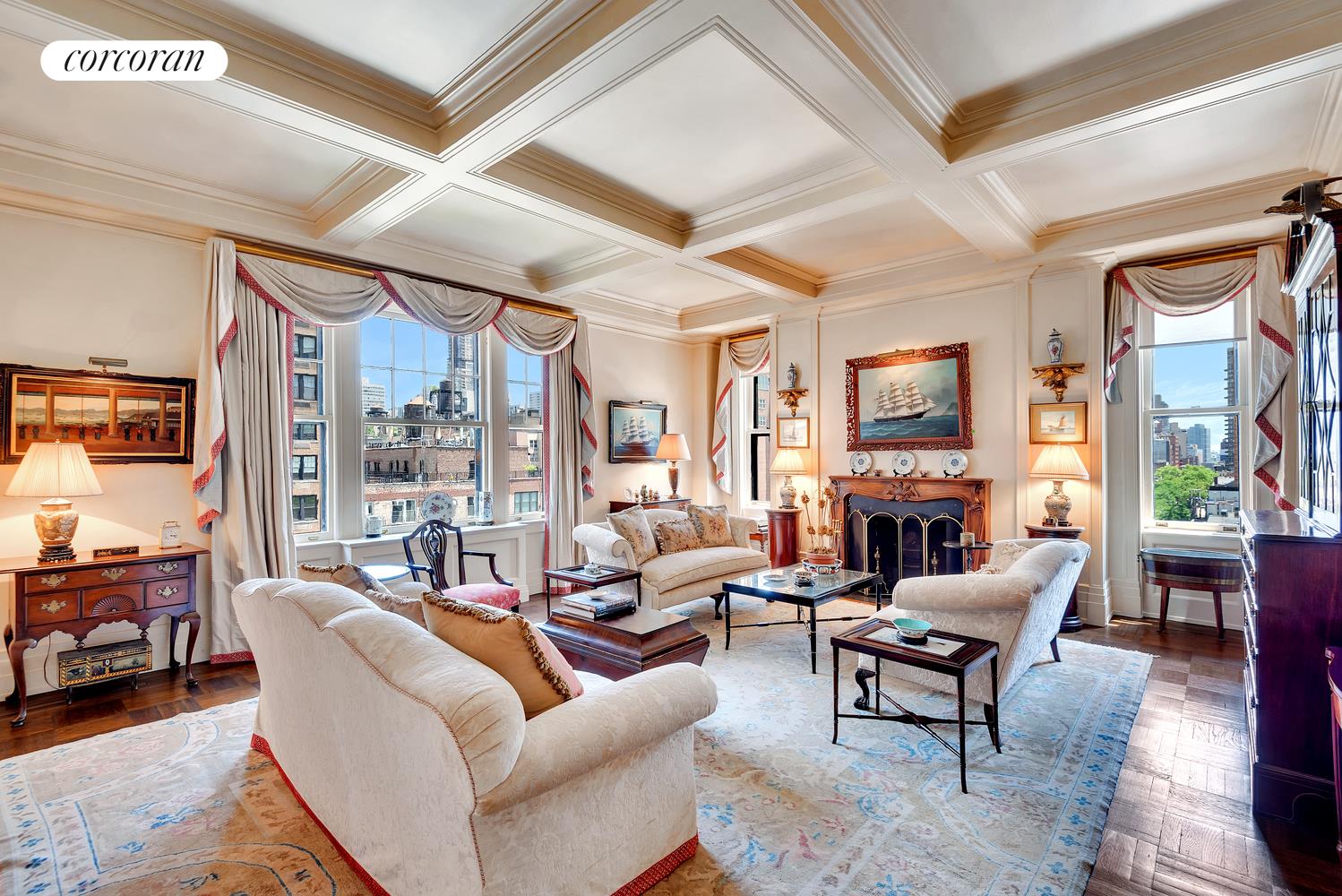 a living room with furniture a fireplace and a large window