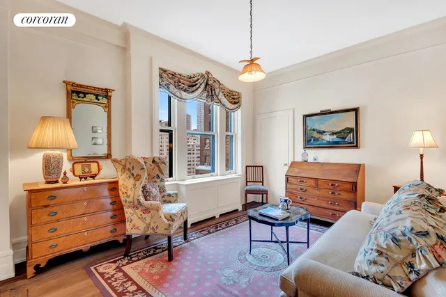 a bedroom with a bed and large windows