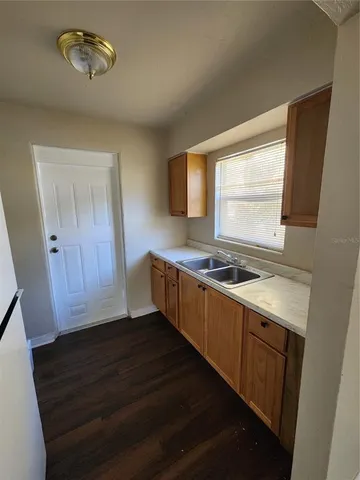 a kitchen with wooden cabinets and a stove top oven