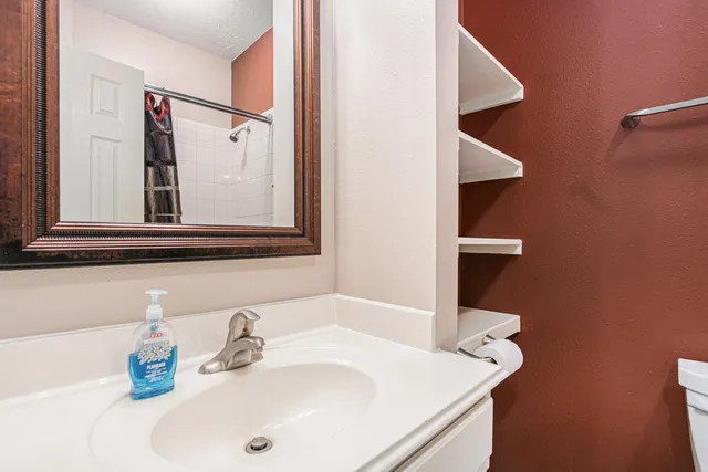 a bathroom with a sink and a mirror