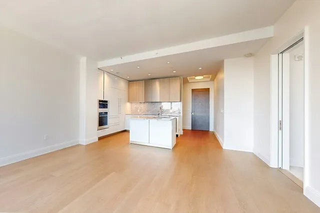 a view of a kitchen with a sink and a refrigerator
