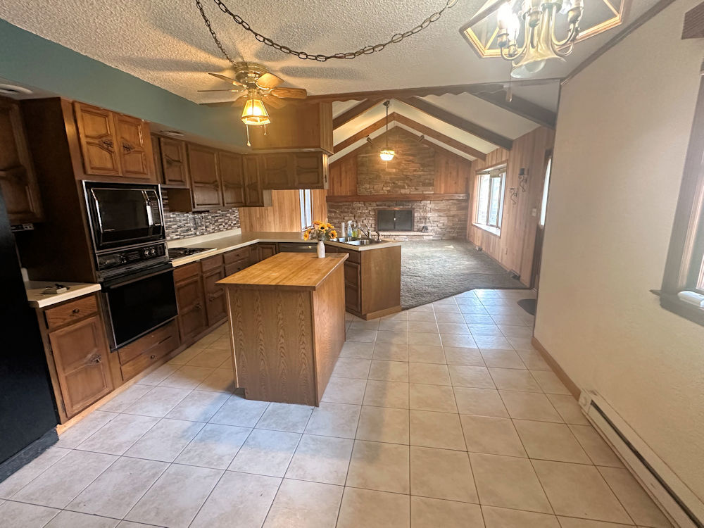516 North 6th Street Rochelle, IL 61068 - Photo 3 of 15 a kitchen with stainless steel appliances granite countertop a sink and a stove