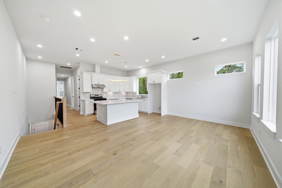 328 Janisch Road, Unit D Houston, TX 77018 - Photo 13 of 37 a view of kitchen with kitchen island white cabinets and refrigerator