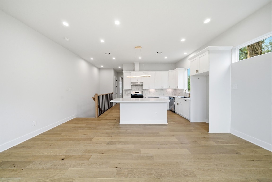 328 Janisch Road, Unit D Houston, TX 77018 - Photo 15 of 37 a large kitchen with kitchen island a stove a refrigerator a sink and a stove