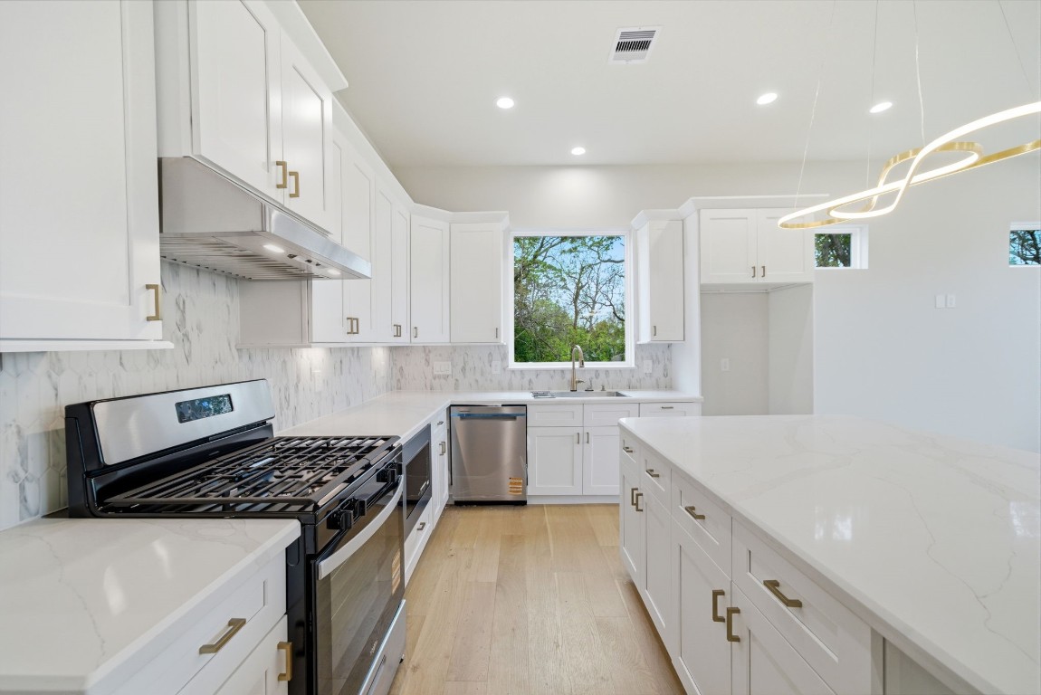 328 Janisch Road, Unit D Houston, TX 77018 - Photo 18 of 37 a kitchen with a sink stove and cabinets