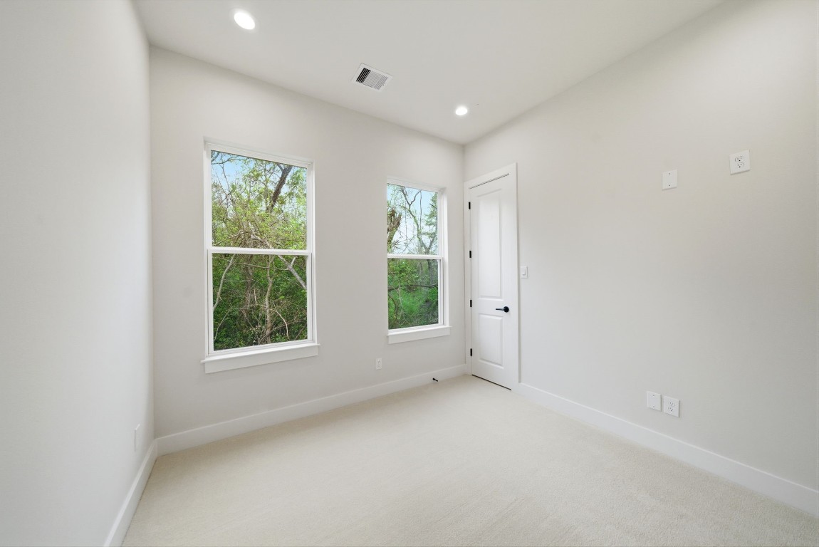 328 Janisch Road, Unit D Houston, TX 77018 - Photo 23 of 37 an empty room with windows and closet