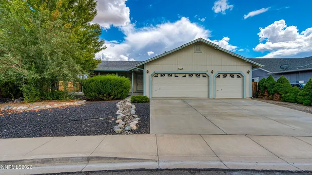 a view of a house with a yard and potted plants