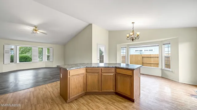 a kitchen with stainless steel appliances granite countertop a sink stove and wooden floor