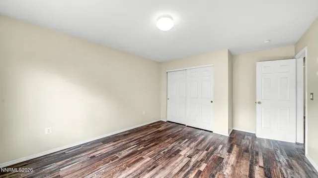 a view of a room with wooden floor and white walls