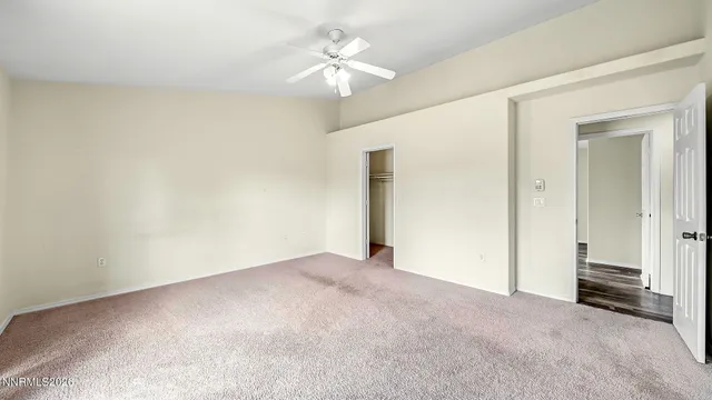 a view of an empty room with a ceiling fan