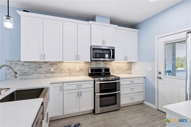 a bathroom with double vanity sinks and a mirror