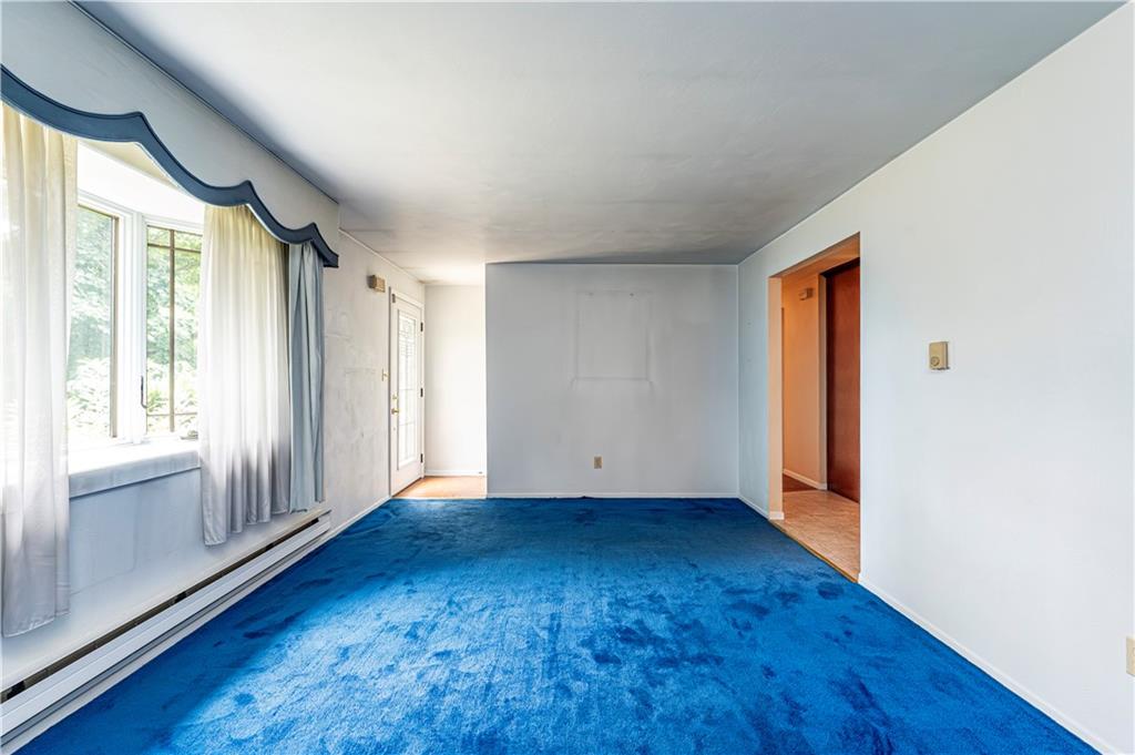 2037 Ridge Road Jeannette, PA 15644 - Photo 4 of 31 a view of an empty room with wooden floor and a window
