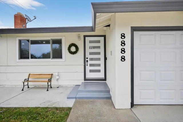 a view of front door of house with seating space