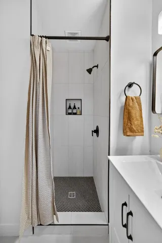 a kitchen with stainless steel appliances granite countertop a stove top oven a sink dishwasher and a refrigerator with wooden floor