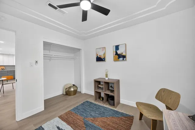 a bedroom with a bed and a ceiling fan