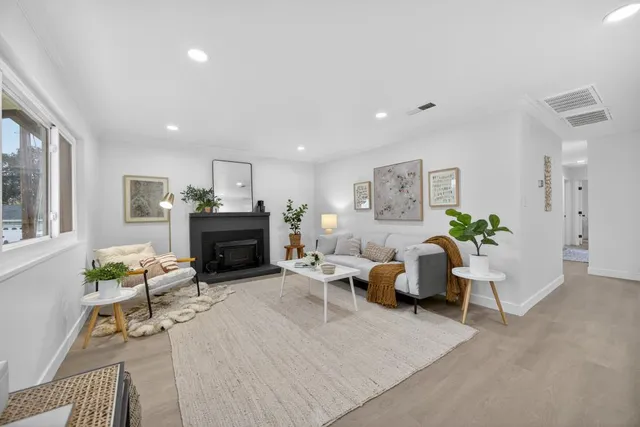 a living room with furniture a fireplace and a table