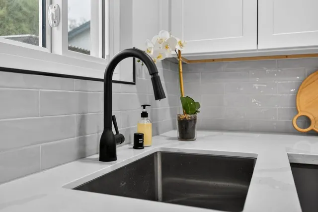 a front view of a house with a yard and trees