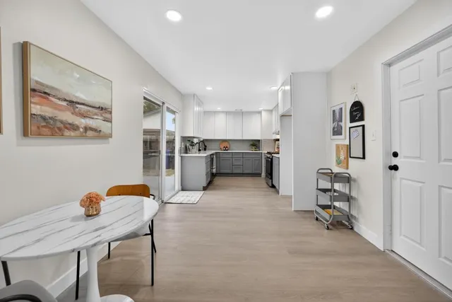 a view of a house with backyard and trees