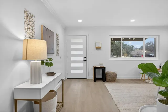 an aerial view of a house with a garden and outdoor seating