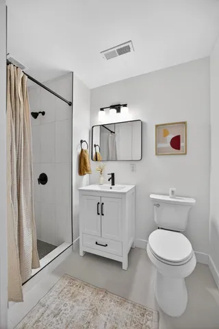 a view of a hallway with bathroom and shower