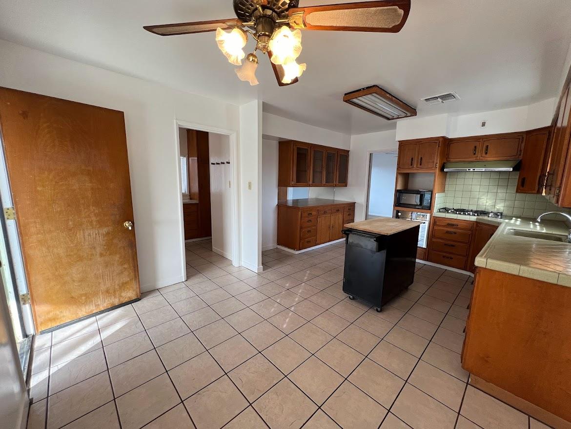 16109 East Manning Reedley, CA 93654 - Photo 6 of 30 a view of a kitchen with furniture and a window