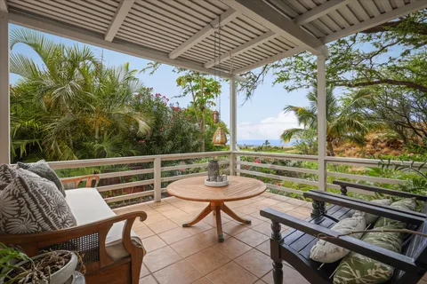 a view of a chairs and table in the balcony