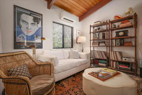 a living room with furniture and a book shelf