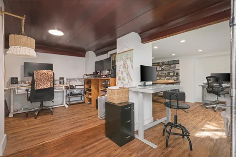 a kitchen with a sink and a large mirror next to a yard