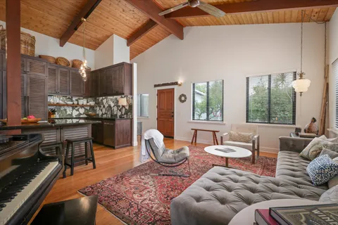 a living room with furniture and a floor to ceiling window