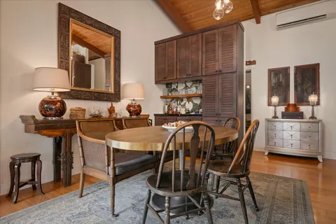 a dining room with furniture and wooden floor