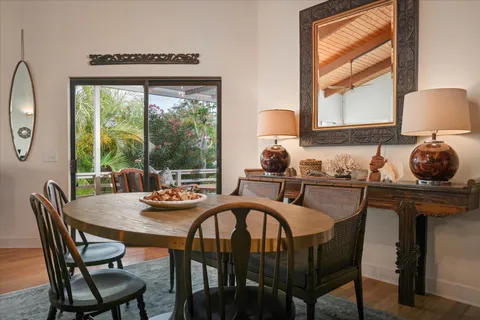 a dining room with furniture a large window and outside view