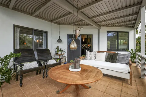 a living room with furniture a table and a potted plant