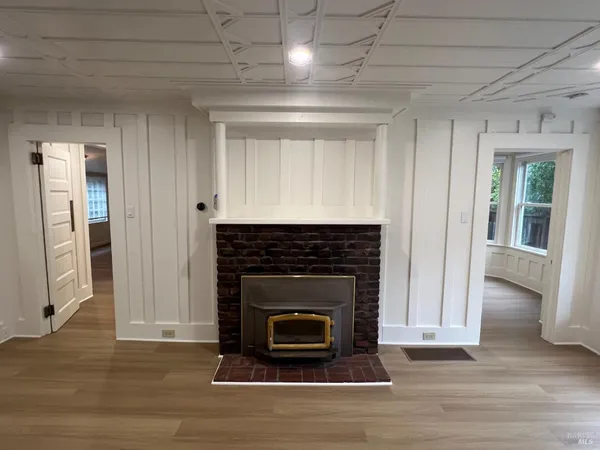 a living room with a fireplace and a wooden floor