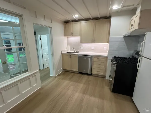 a kitchen with stainless steel appliances granite countertop a refrigerator and a sink