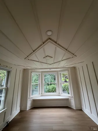 a view of room with window and hardwood floor