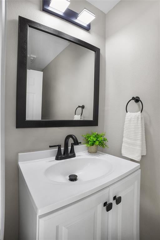 2700 Club Ridge Drive, Unit 2 Lewisville, TX 75067 - Photo 16 of 25 a bathroom with a sink and a mirror
