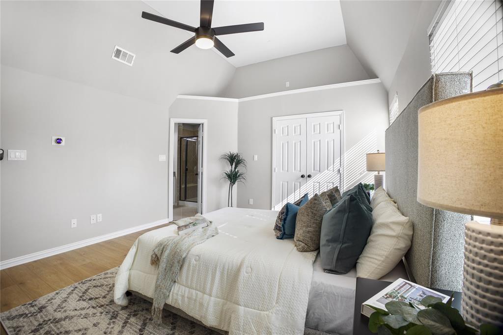 2700 Club Ridge Drive, Unit 2 Lewisville, TX 75067 - Photo 19 of 25 a bedroom with a bed and wooden floor