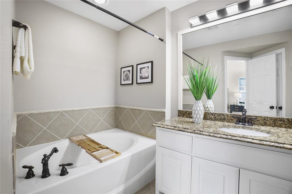 2700 Club Ridge Drive, Unit 2 Lewisville, TX 75067 - Photo 23 of 25 a bathroom with a sink and a mirror