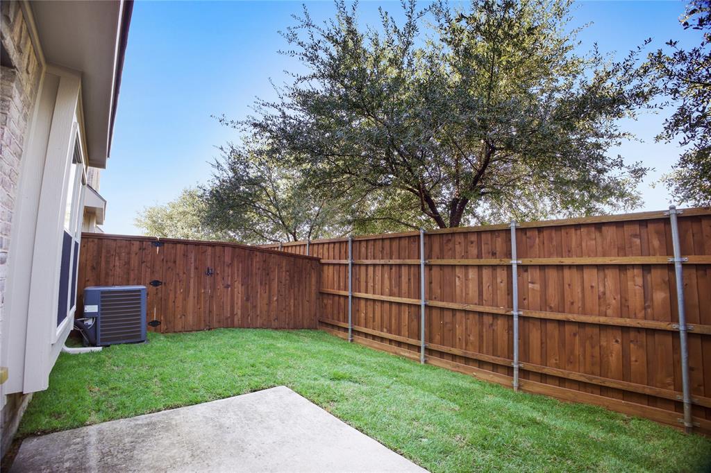 2700 Club Ridge Drive, Unit 2 Lewisville, TX 75067 - Photo 25 of 25 a view of a backyard with a wooden fence