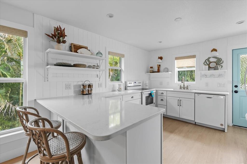 1306 McGregor Street Punta Gorda, FL 33950 - Photo 11 of 29 a kitchen with a dining table chairs cabinets and window