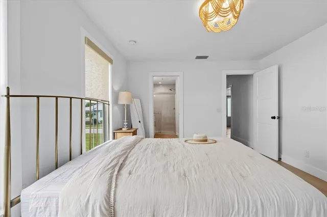 a bedroom with a large bed and a large window