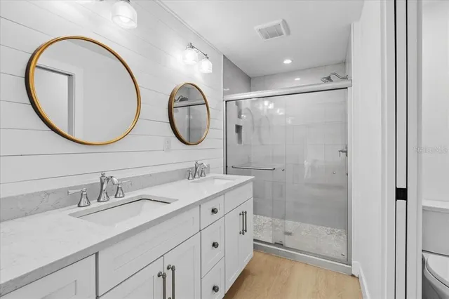 a bathroom with a double vanity sink and a mirror