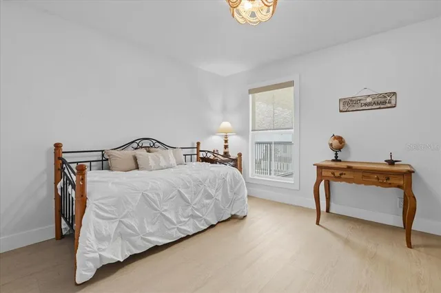 a bedroom with bed and window