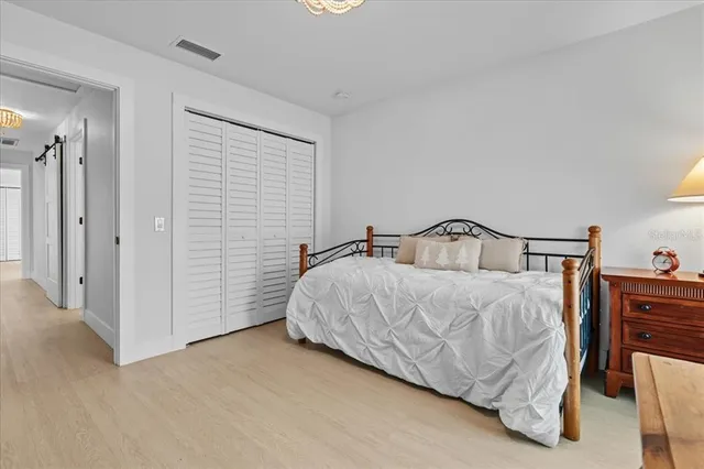 a bedroom with a bed and cabinets