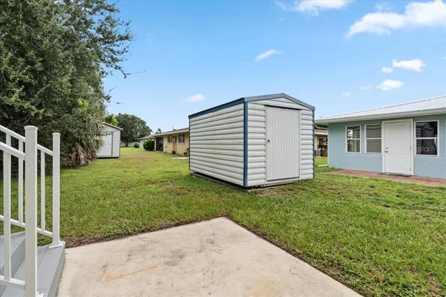 a backyard of a house with plants and entertaining space