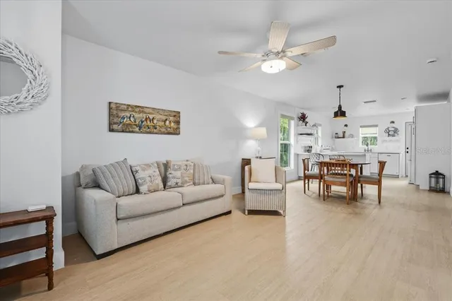 a living room with furniture and kitchen view