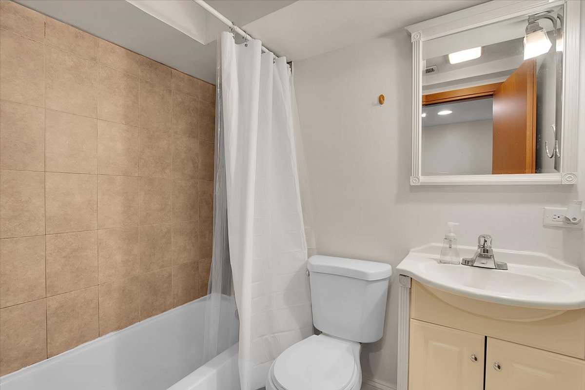 1647 West Sherwin Avenue, Unit 1 Chicago, IL 60626 - Photo 14 of 22 a bathroom with a sink toilet and shower