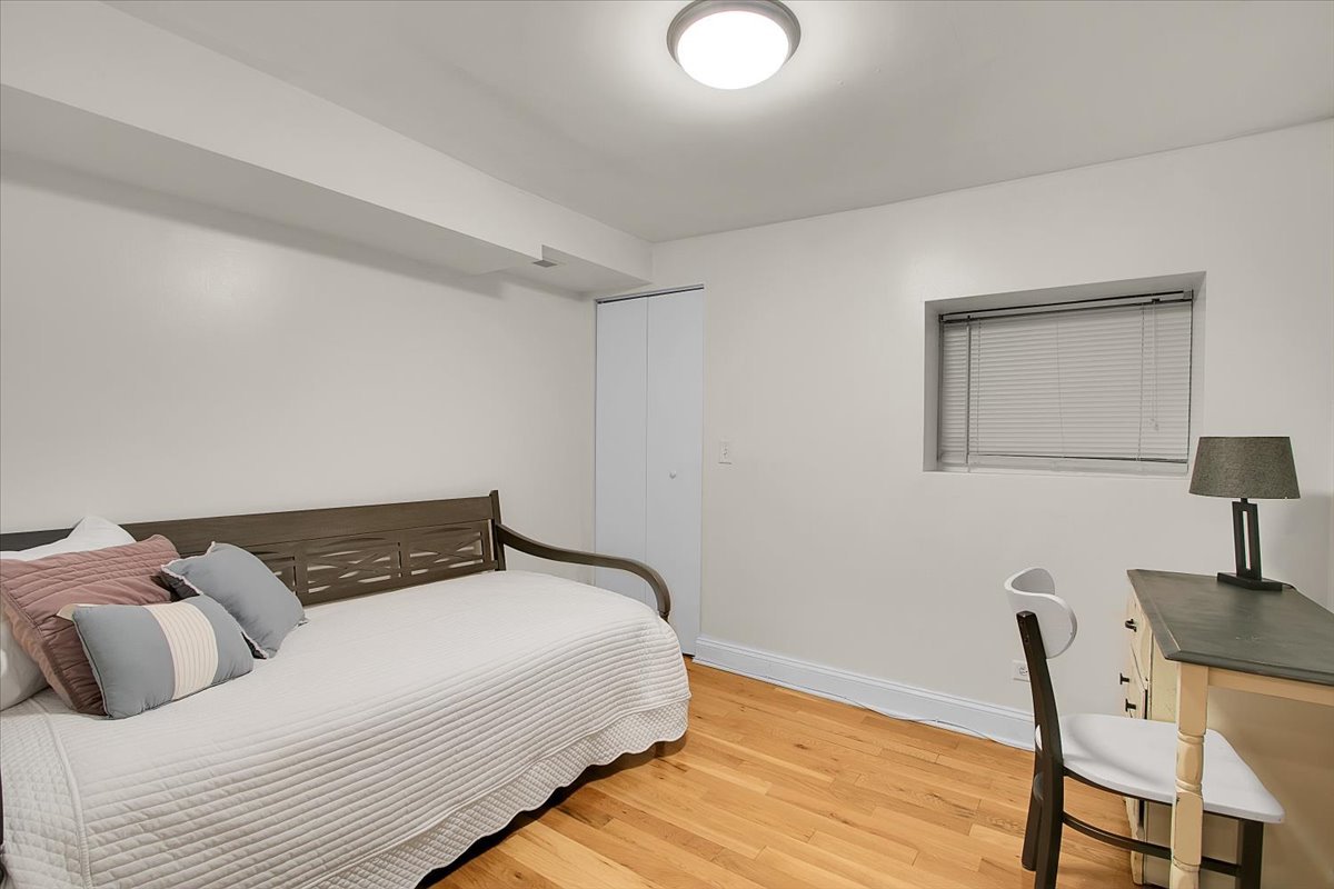 1647 West Sherwin Avenue, Unit 1 Chicago, IL 60626 - Photo 15 of 22 a bedroom with a bed and wooden floor