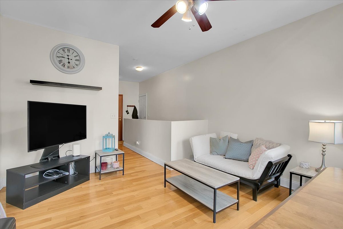 1647 West Sherwin Avenue, Unit 1 Chicago, IL 60626 - Photo 5 of 22 a living room with furniture and a flat screen tv